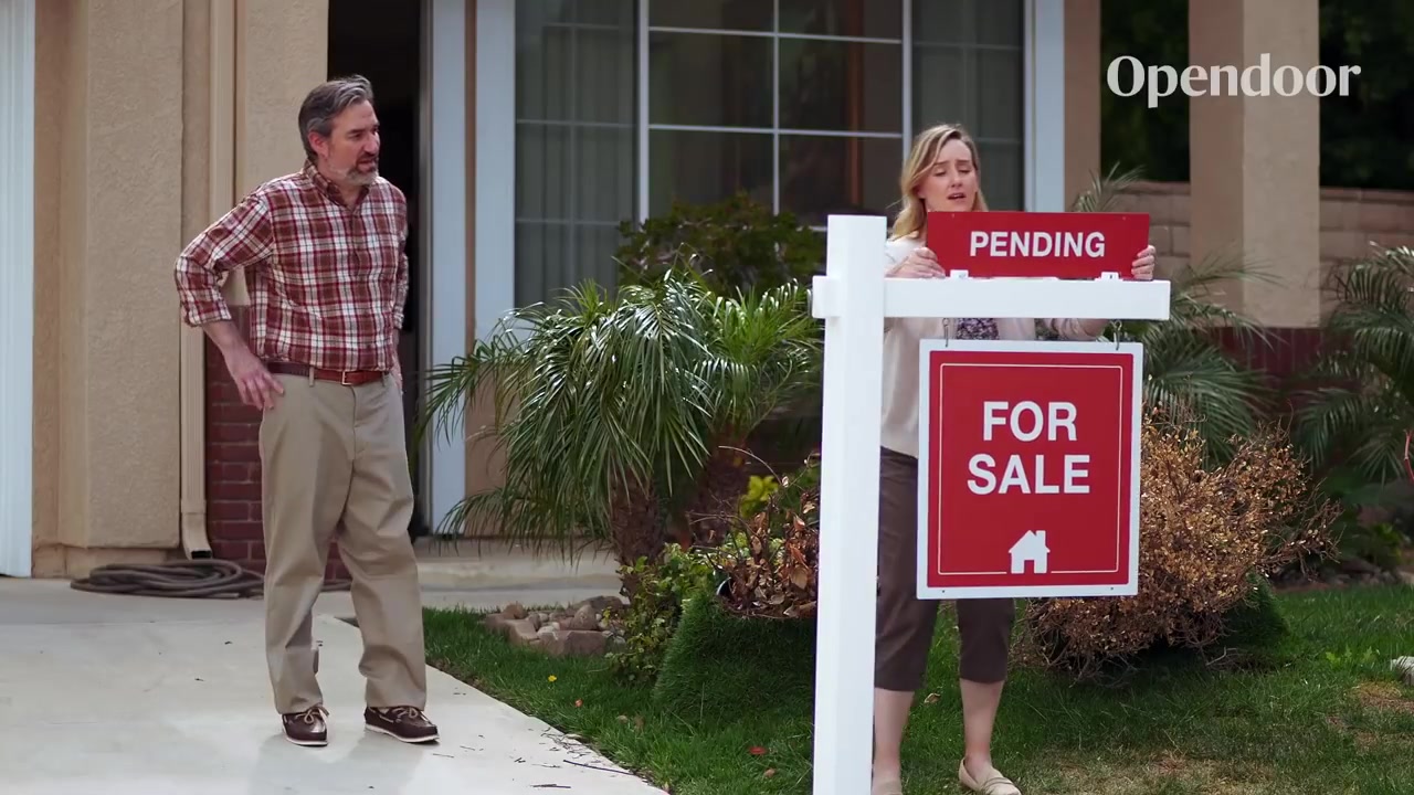 couple in front of home for sale